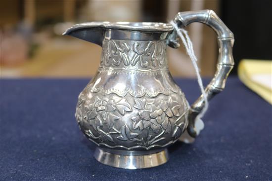 A Chinese cream jug and a small group of mixed metal items.